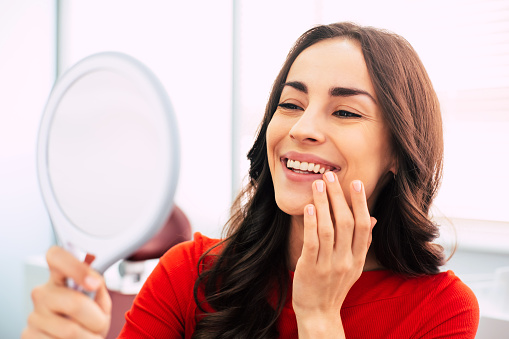 woman smiling in front of mirror